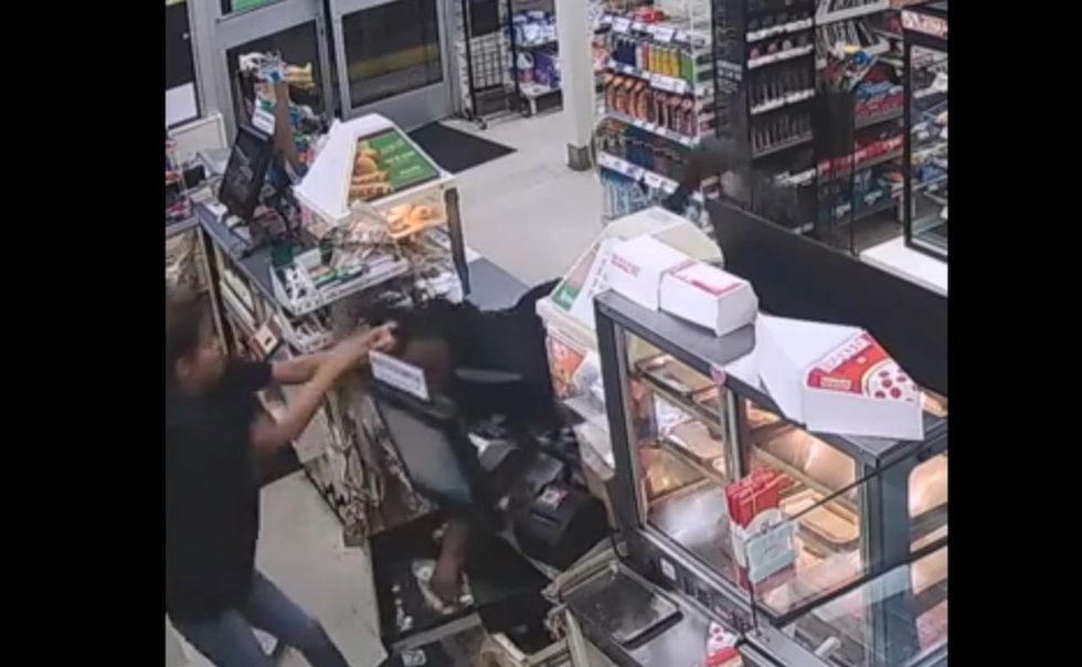 VIDEO: Crook grabs for cash in register. But store clerk — thinking of her family — isn't having it.