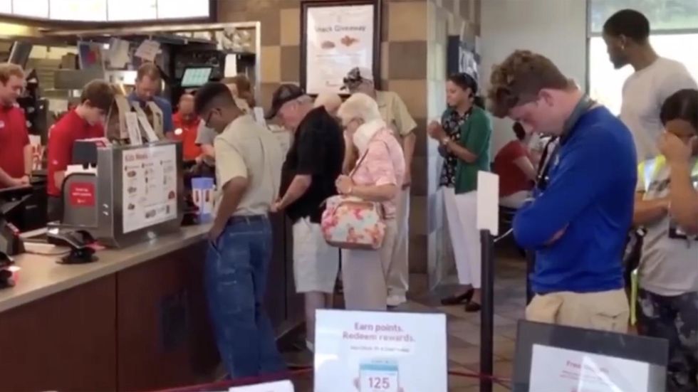 WATCH: In moving moment, Chick-fil-A workers, patrons gather and pray for employee with cancer