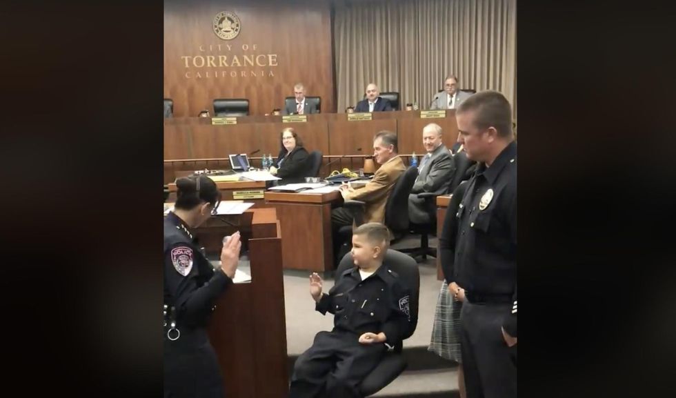 Terminally ill 7-year-old sworn in as honorary police officer so he could follow in dad's footsteps