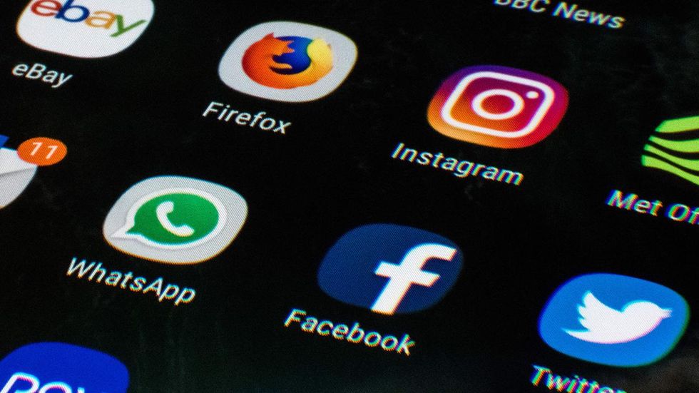 Russian operative charged in conspiracy to influence mid-term elections, cause social discord