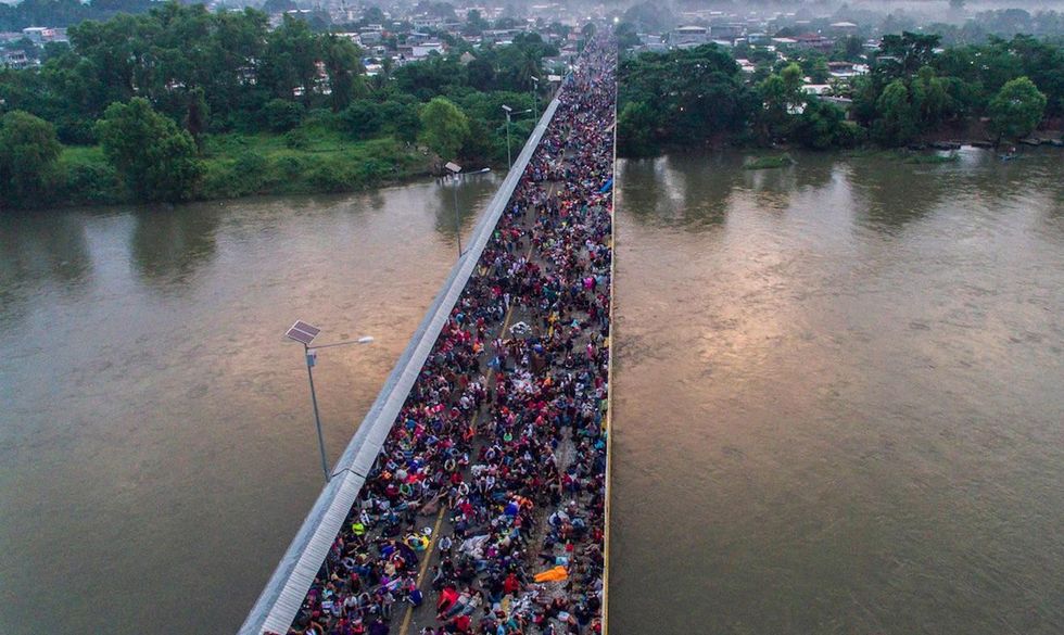 Standoff overnight at Mexico's southern border as migrant caravan of thousands tries to reach US