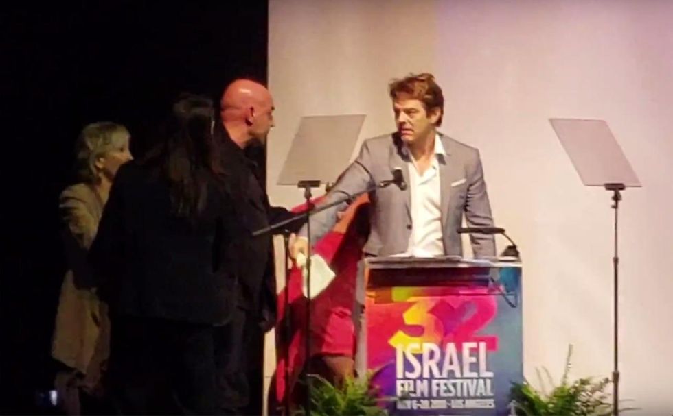 Producer booed for anti-Trump remarks at Israel Film Festival; actor tries pulling him off stage