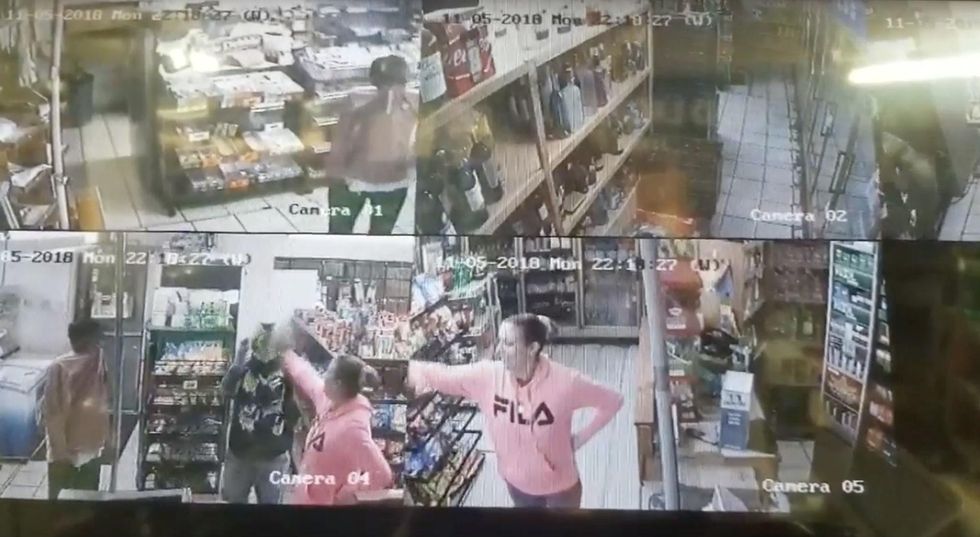 Armed female store manager doesn't bat an eye fighting back when burglars put a gun in her face