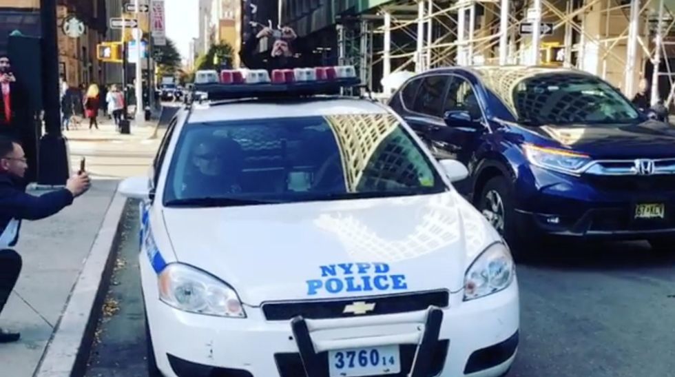 NYPD officer’s antics in a parked police cruiser go viral — and get big reaction