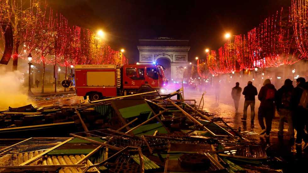 Angry French protesters start fires, clash with police over Macron gas tax hikes