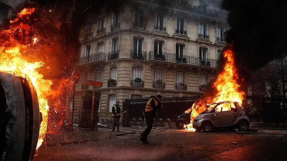 Chaos in Paris as rioters torch cars, smash windows; French President Macron plans emergency meeting