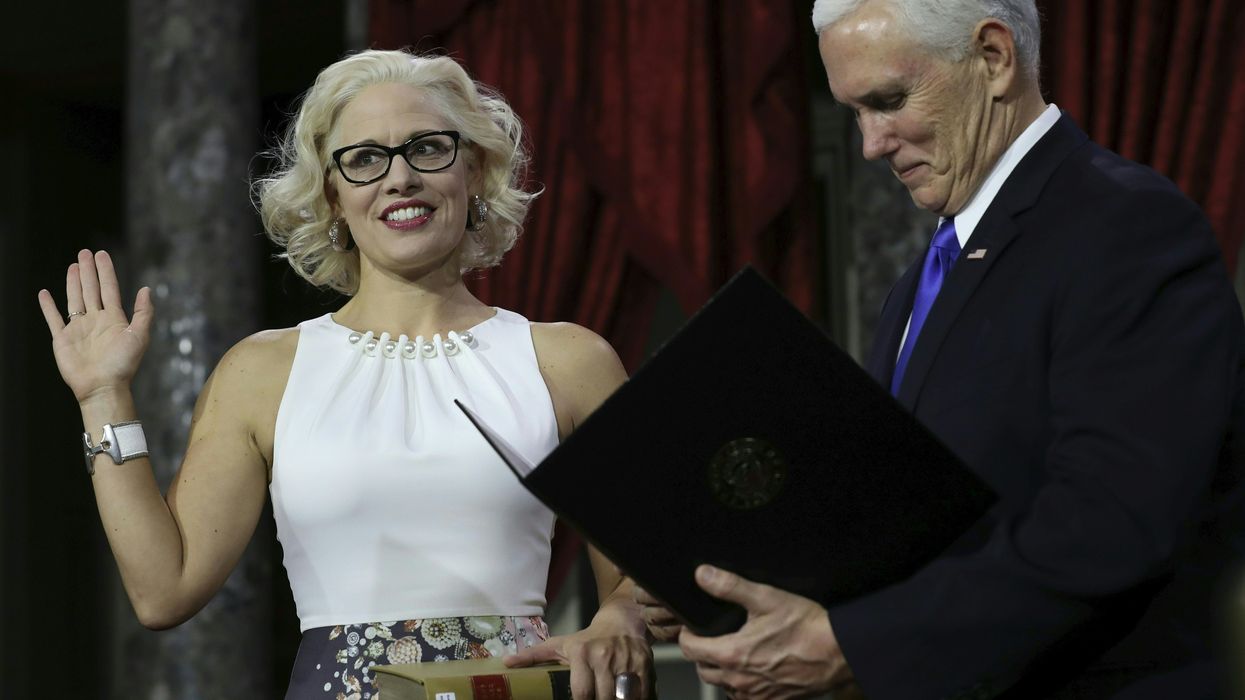 Kyrsten Sinema, first openly bisexual senator, is sworn in — but on the Constitution and not the Bible