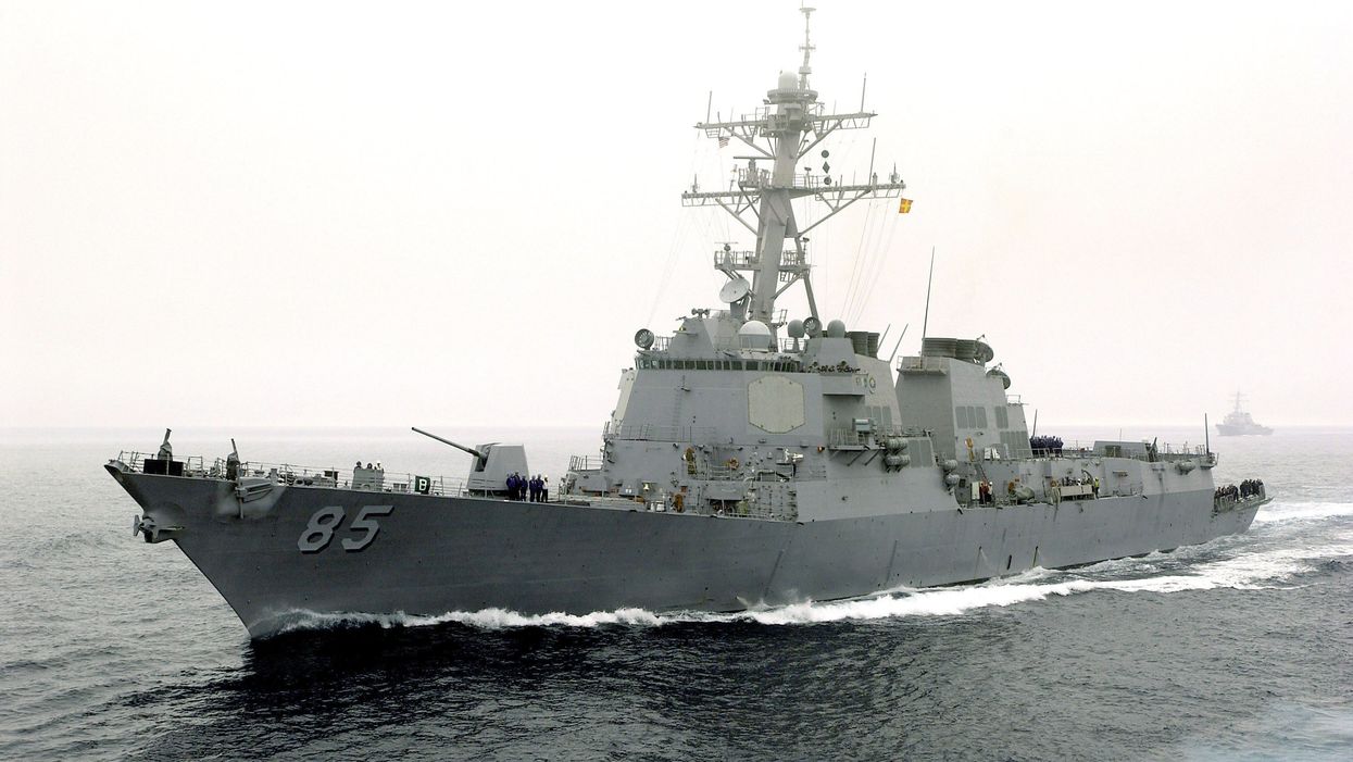 China accuses America of 'provocation' during trade negotiations after Navy destroyer sails through disputed waters