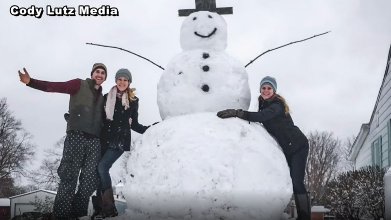 Man and fiancee build 9-foot snowman in front yard. Motorist apparently tries to destroy it — but karma kicks in instantaneously.