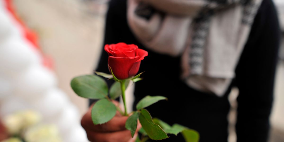 Passing Out Roses For eight years now, a group of men has been passing out roses to ...