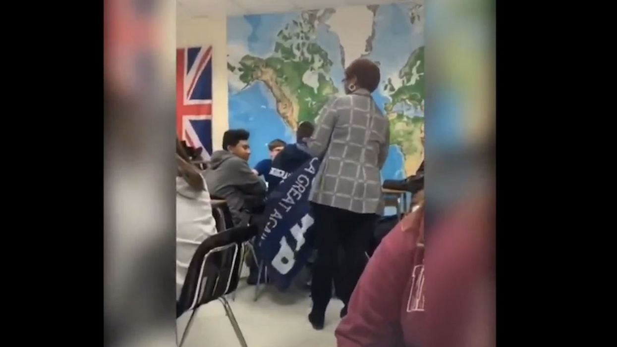 WATCH: Teacher's aide appears to wrap pro-Trump banner around student's head; school gets threatening calls after incident