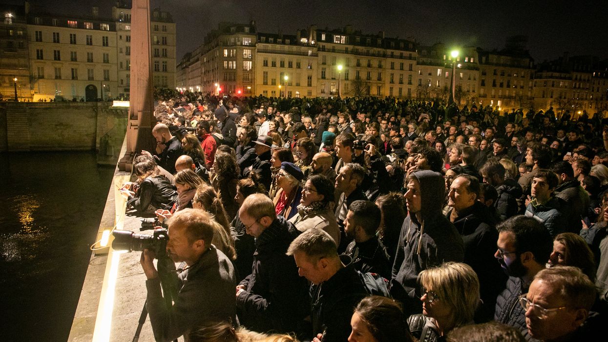WATCH: Onlookers kneel, sing 'Ave Maria' as they watch the Notre Dame Cathedral burn