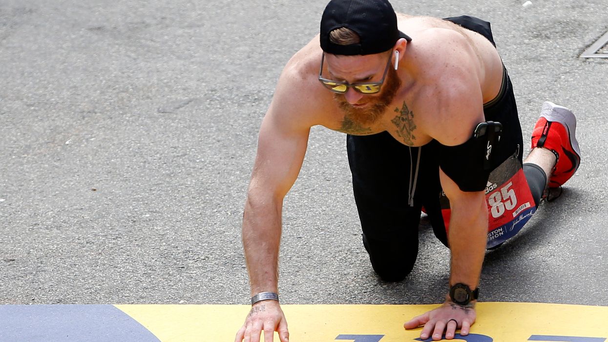 Marine drags himself across finish line of Boston Marathon in honor of comrades who died next to him in combat