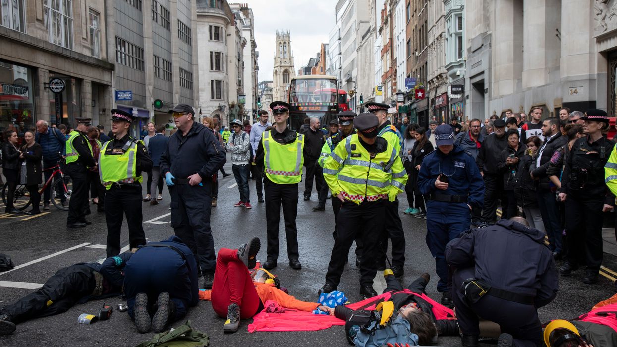 Woman glues her breasts to the ground in one-woman protest against climate change