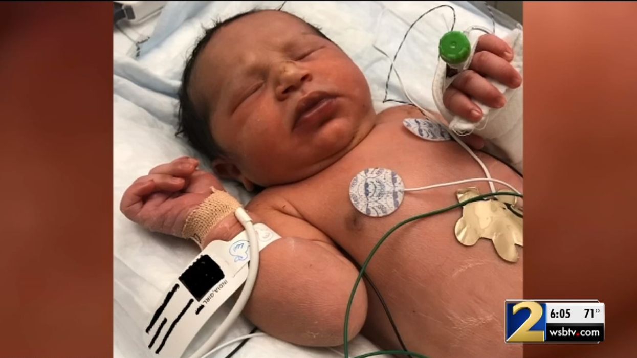 Georgia authorities search for mother of baby found alive wrapped in a plastic bag in woods at night