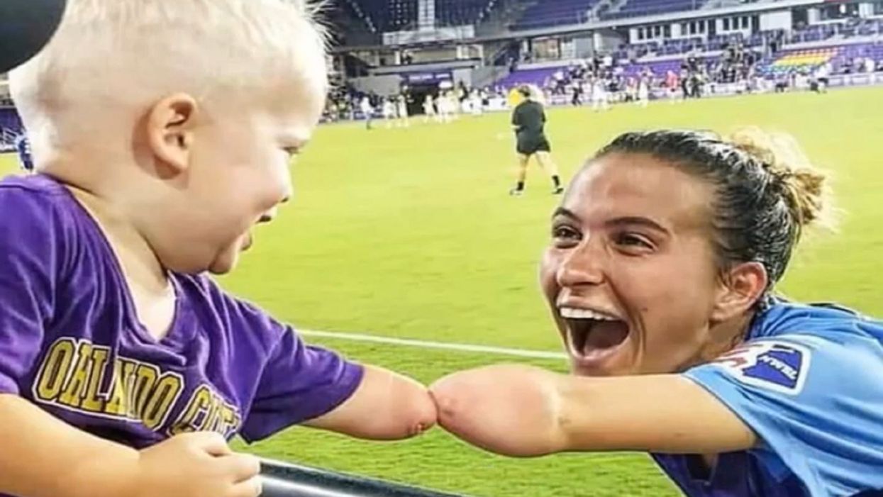 Heartwarming photo captures 'fist' bump between toddler and pro soccer player with matching limb difference