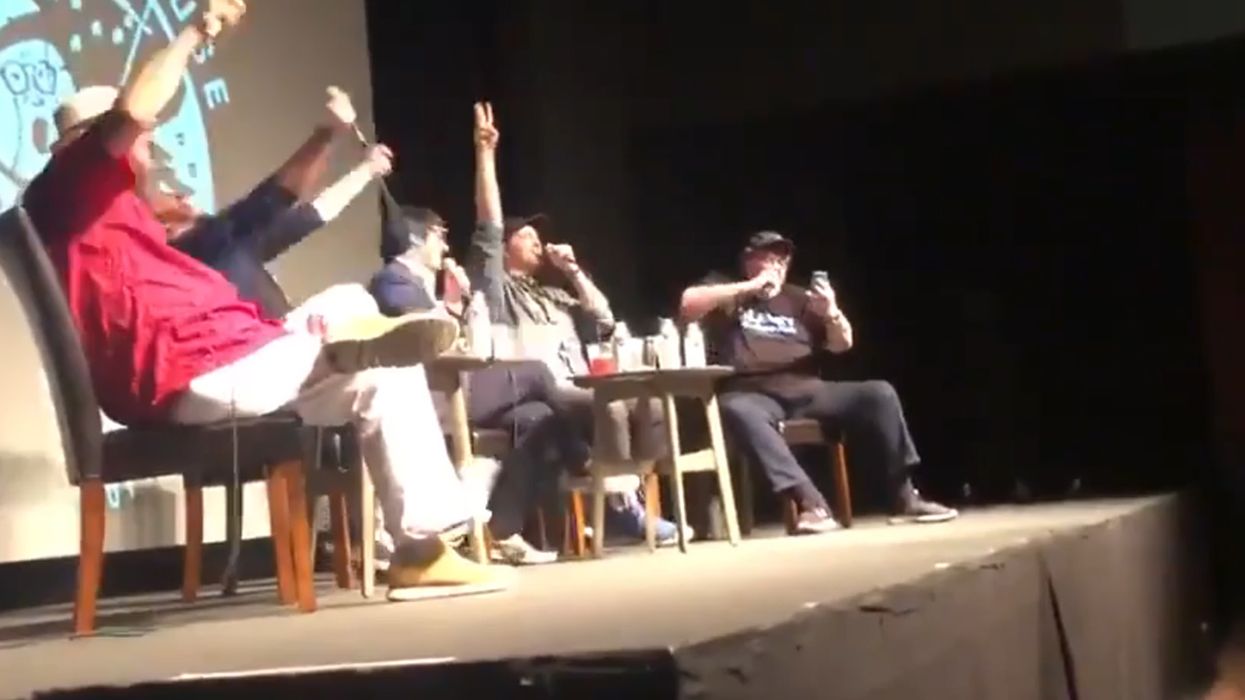 Watch Michael Moore weirdly rap the Kamala Harris student debt plan as white liberal crowd badly attempts to drop beat