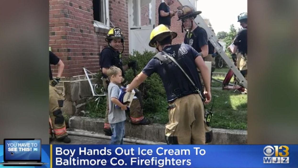 Firefighters battle intense house fire. Area boy is on hand to reward them with ice cream sandwiches.