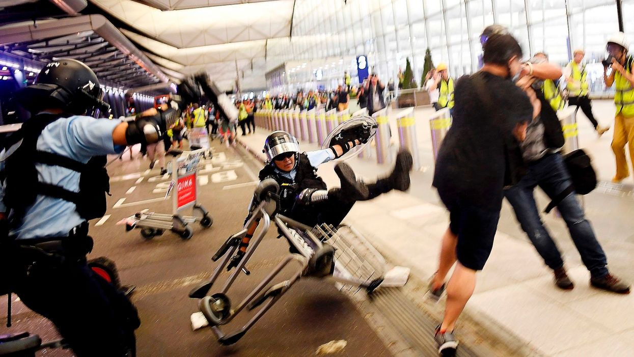 Protesters clash with riot police at Hong Kong's airport for 5th straight day — here's what they're fighting over
