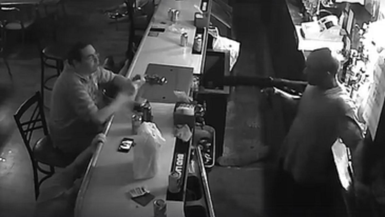 Watch: Unfazed bar patron casually lights cigarette at gunpoint during armed robbery
