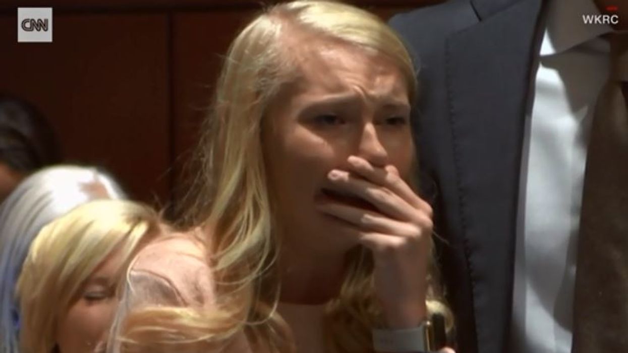 Woman who buried baby she had as a high school cheerleader cleared of murder and manslaughter charges
