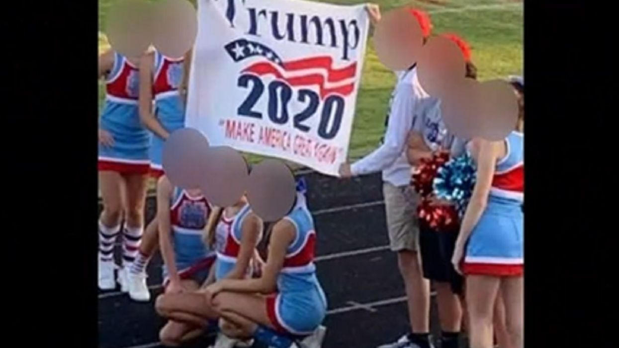 High school cheerleading squad on probation for the rest of the year for holding a Trump 2020 banner