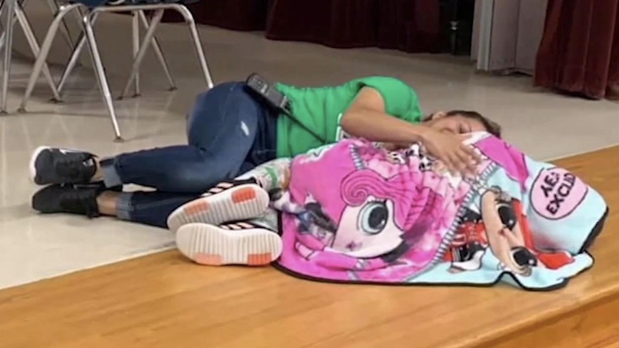 Fourth grader with autism is overwhelmed, lays down with blanket, and cries alone. Then school's custodian enters the moment.