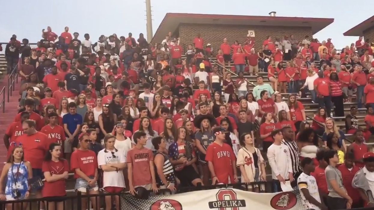 Atheists' complaint leads to ban on school-sponsored prayer before football games. So students recite 'The Lord's Prayer' on their own.