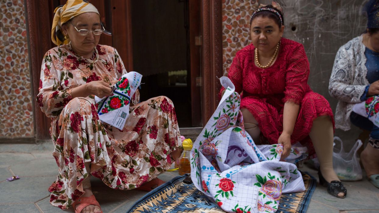Video may show hundreds of blindfolded minority Chinese Uighurs being led to a detention camp by Chinese forces