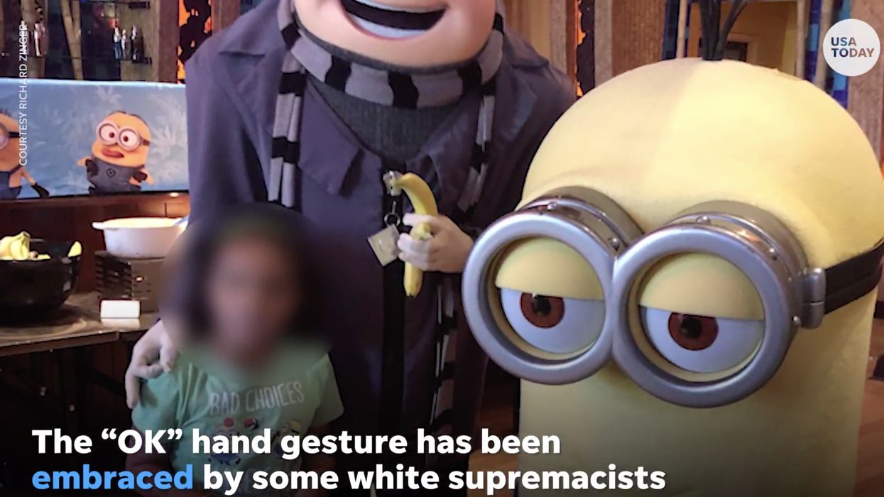 Family outraged after Universal Studios employee makes 'OK' sign in photo with their 7-year-old daughter. Now the employee is out of a job.