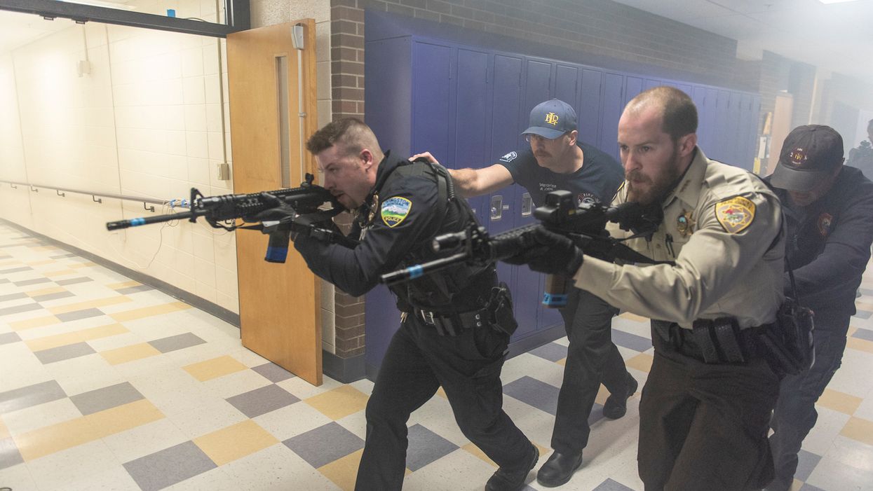 Police fire shotgun and rifle blanks during high school active shooter drill
