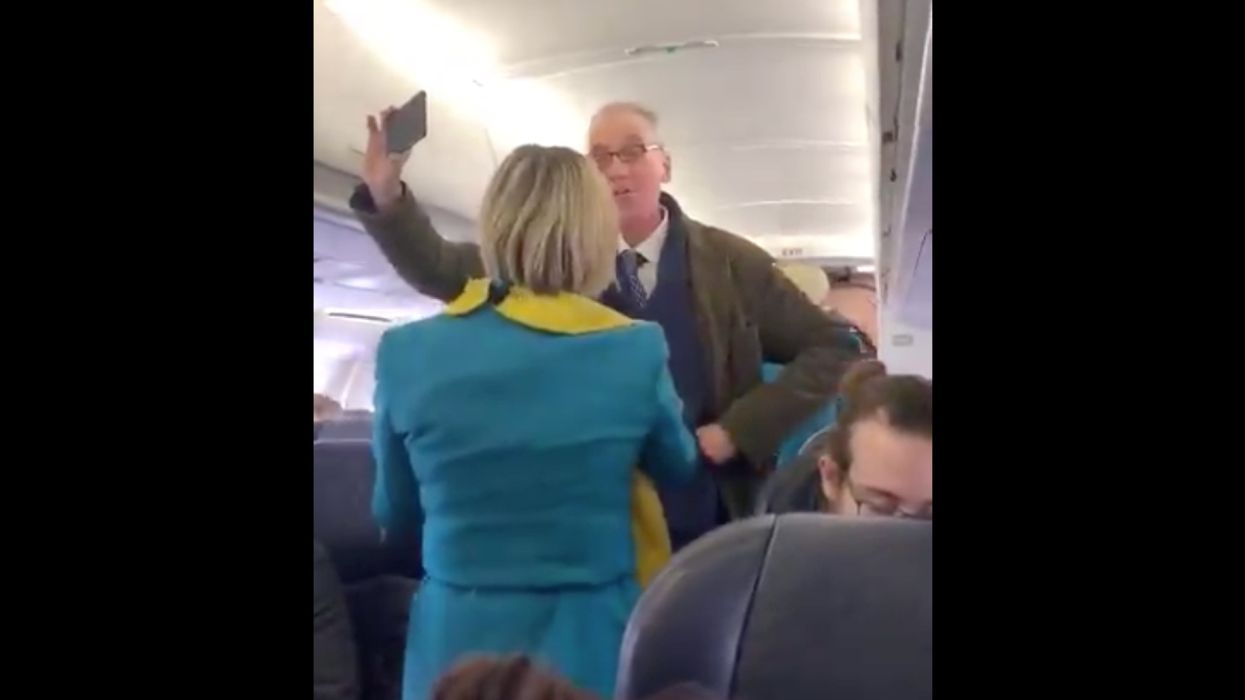 Climate change protester bent on delaying flight gets heckled by fellow passengers while a BBC editor on board points out some serious irony