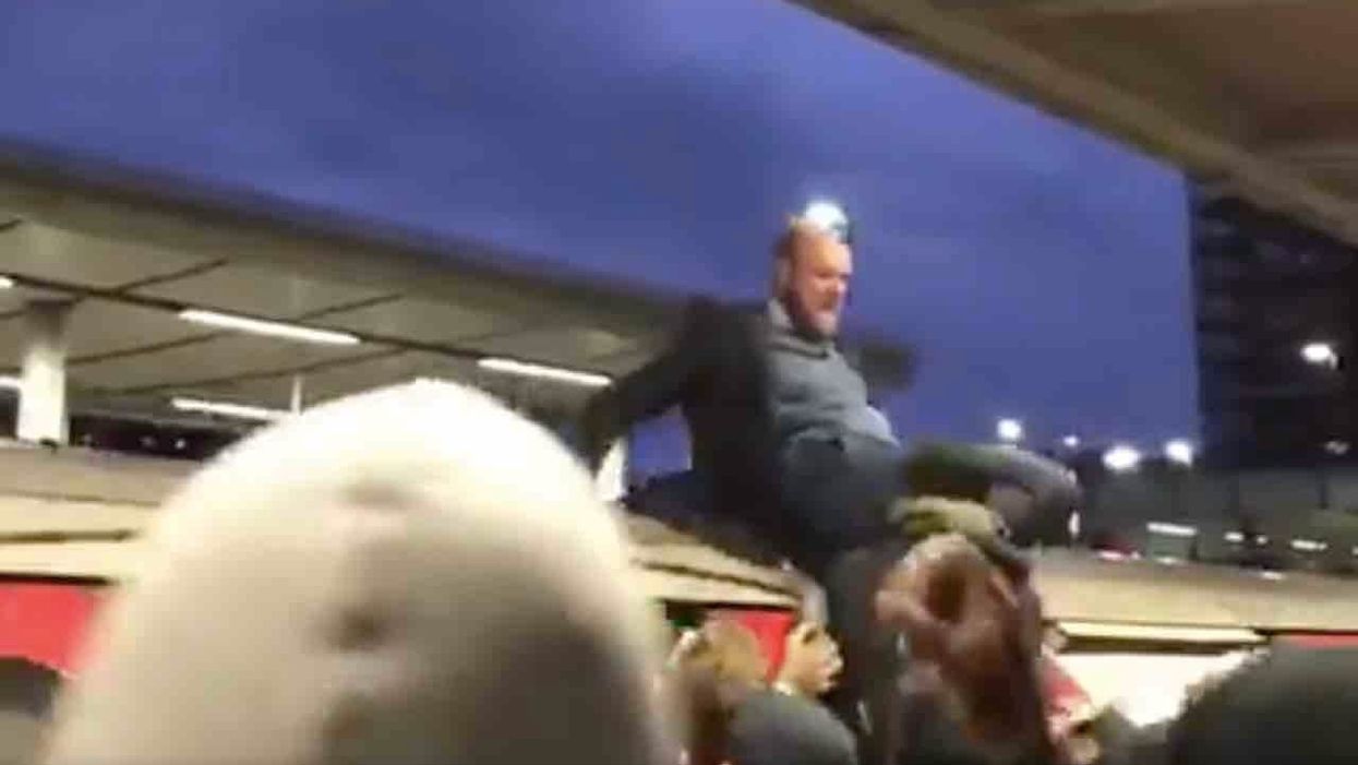 Climate change activist stands atop London train, infuriating delayed commuters. So they drag him off the roof.