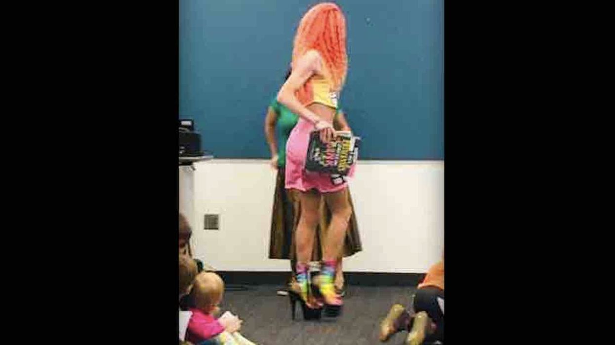 Photo shows Drag Queen Story Hour performer in miniskirt exposing crotch as children sit close by