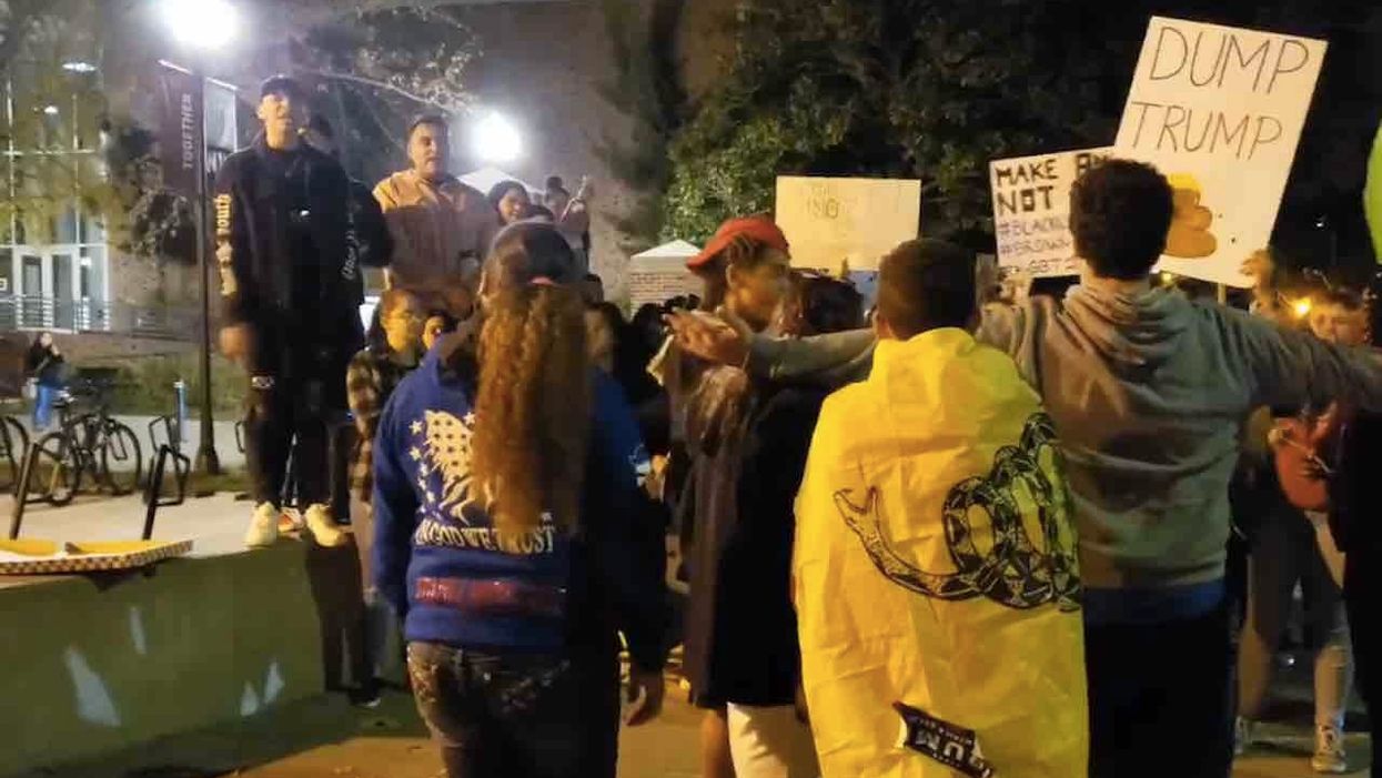 Black supporters of President Trump stand up to left-wing mob harassing them amid campus protest