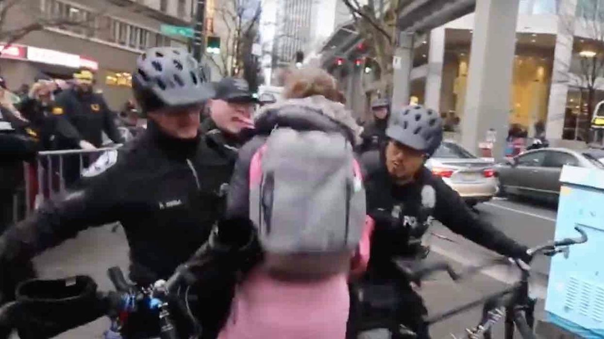 Woman protesting with Antifa tries rushing police line. But cops aren't playing — and shove her right to the pavement.