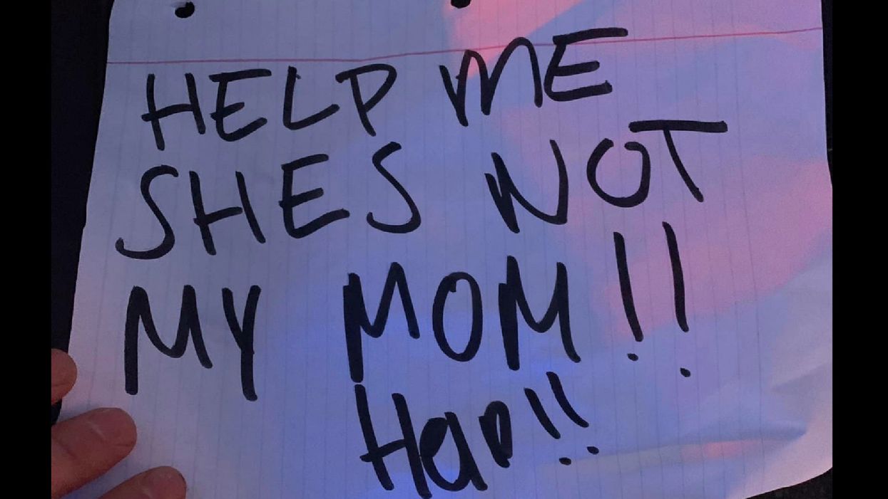 Child's backseat 'Help me, she's not my mom!' sign prompts massive police presence. Child says it was all just a joke.