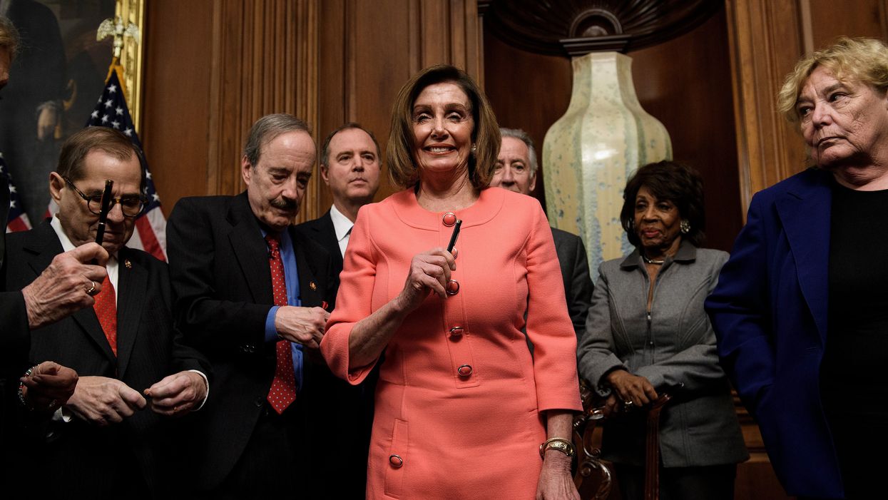 'Somber' Nancy Pelosi hands out souvenir pens used to sign impeachment bill
