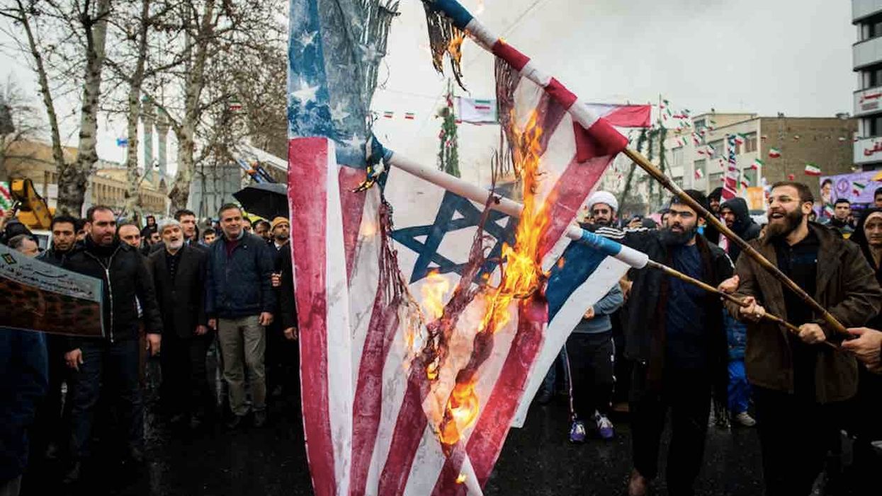 Iranian factory hand prints US, Israeli flags to burn at protests. Worker says flag burning is 'the least that can be done' against 'cowardly' US.