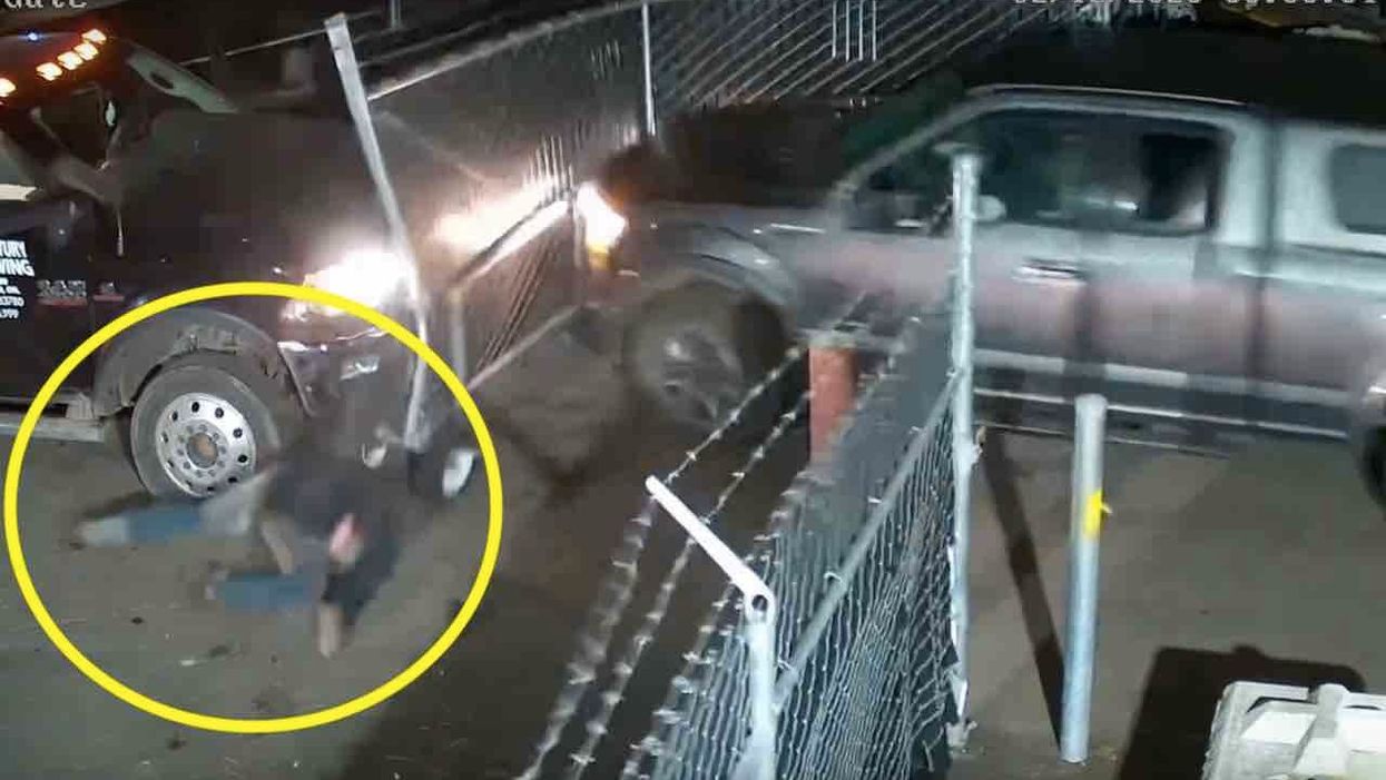 VIDEO: Woman sneaks into towing yard, allegedly takes her truck, rams through fence, smashes company vehicle — and sends employee flying