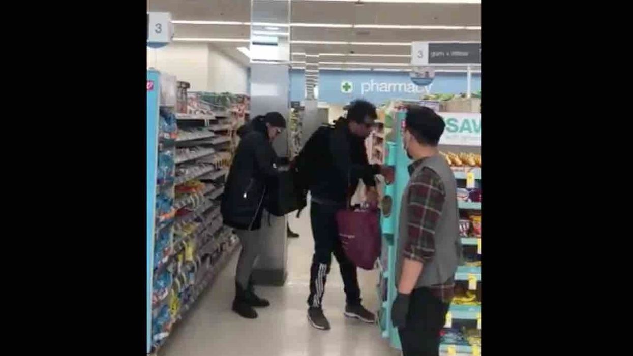 'Pieces of s**t!': Brazen couple caught on video casually looting Walgreens amid coronavirus as employee helplessly watches