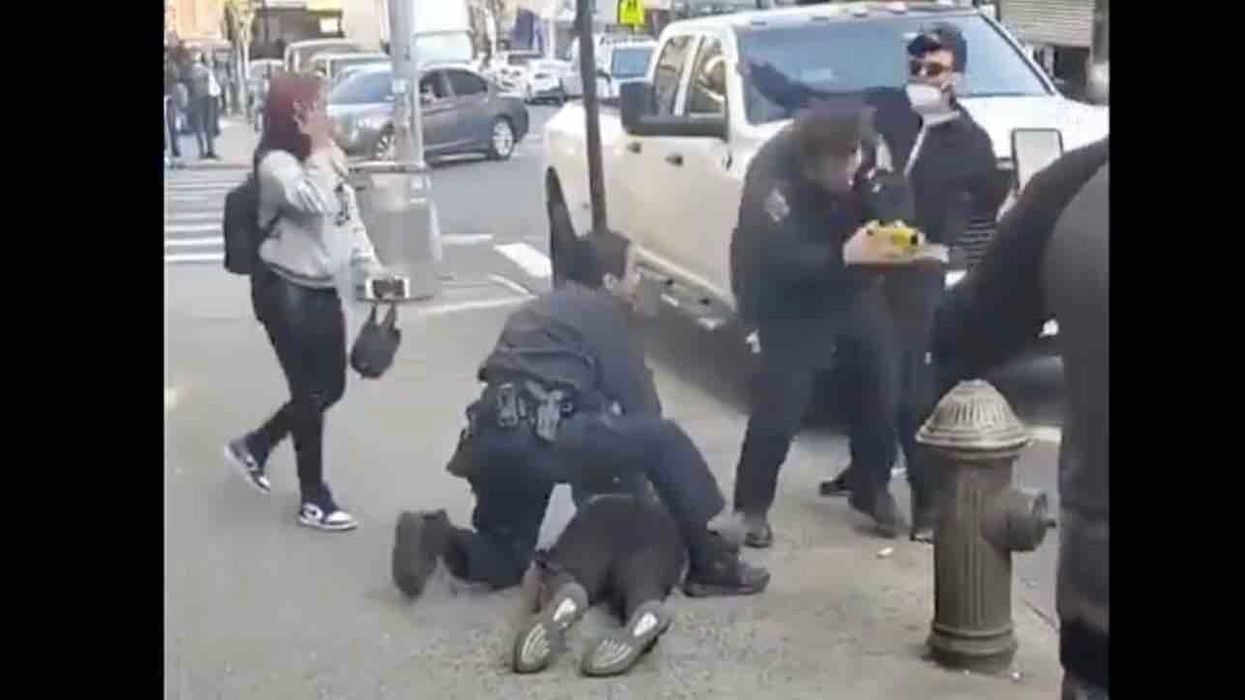 Thug wearing medical mask sucker punches NYPD officer from behind — and onlookers cheer for culprit as he runs away