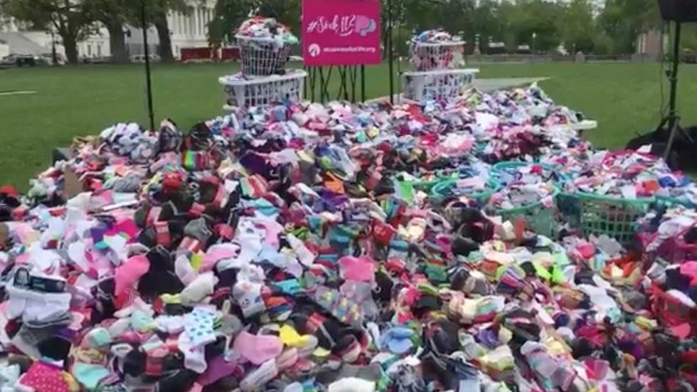 A mountain of baby socks reminds of PP’s grisly business