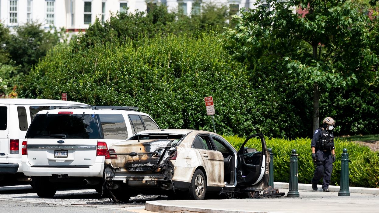 Police car torched outside Supreme Court, suspect in custody