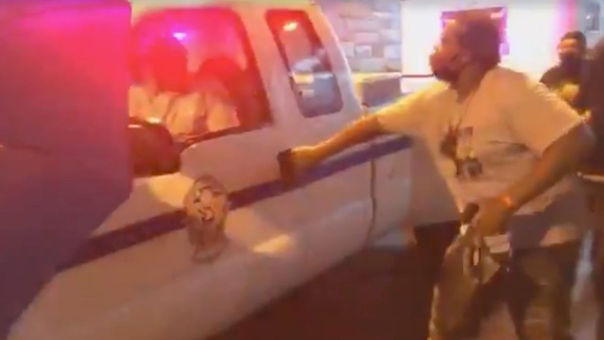 Disturbing video shows BLM protesters block police vehicle, attempt to open door — but officer fights back