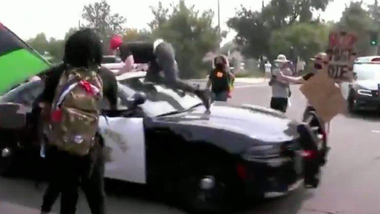 VIDEO: Man injured when he flies off of police car during mob attack by anti-Trump protesters in California