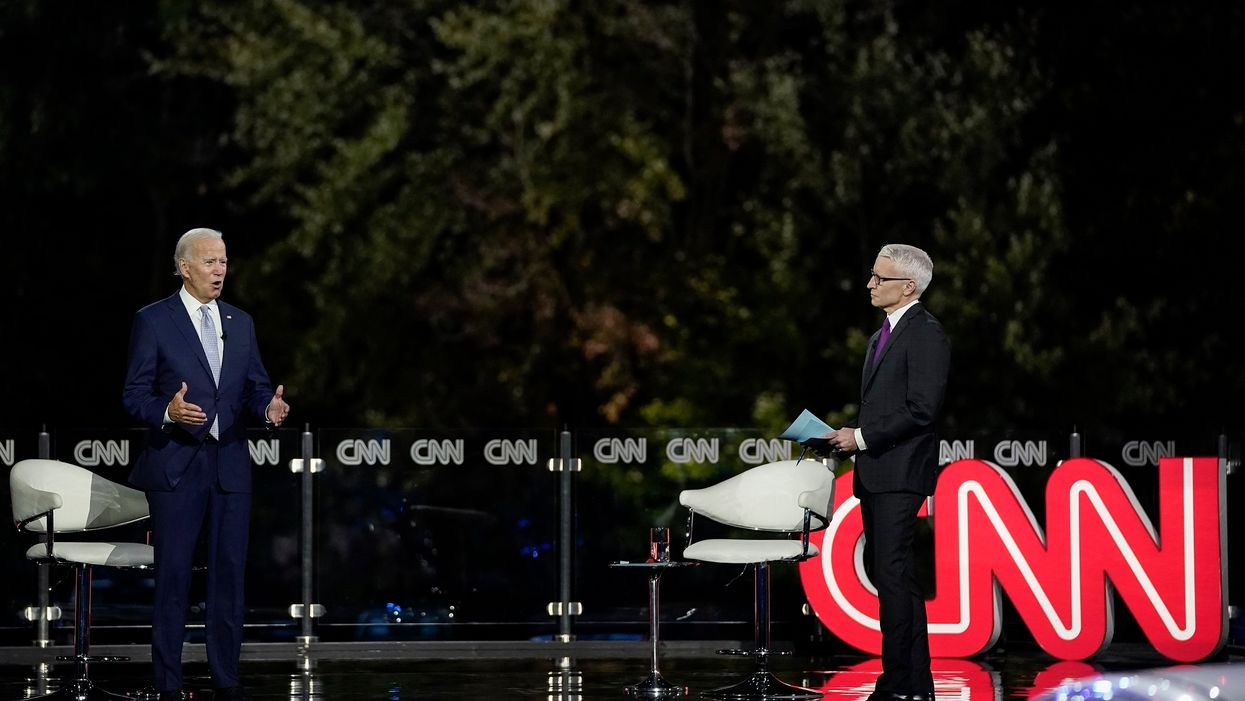 Joe Biden and Anderson Cooper slammed for scrapping social distancing as the cameras pull away