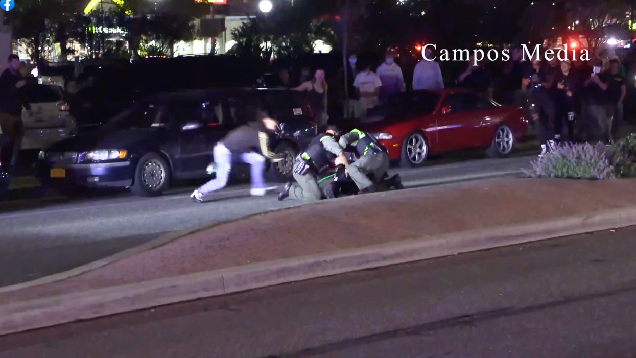 UPDATED: Insane video shows huge police presence during unauthorized beach car rally event as one rallygoer assaults group of officers