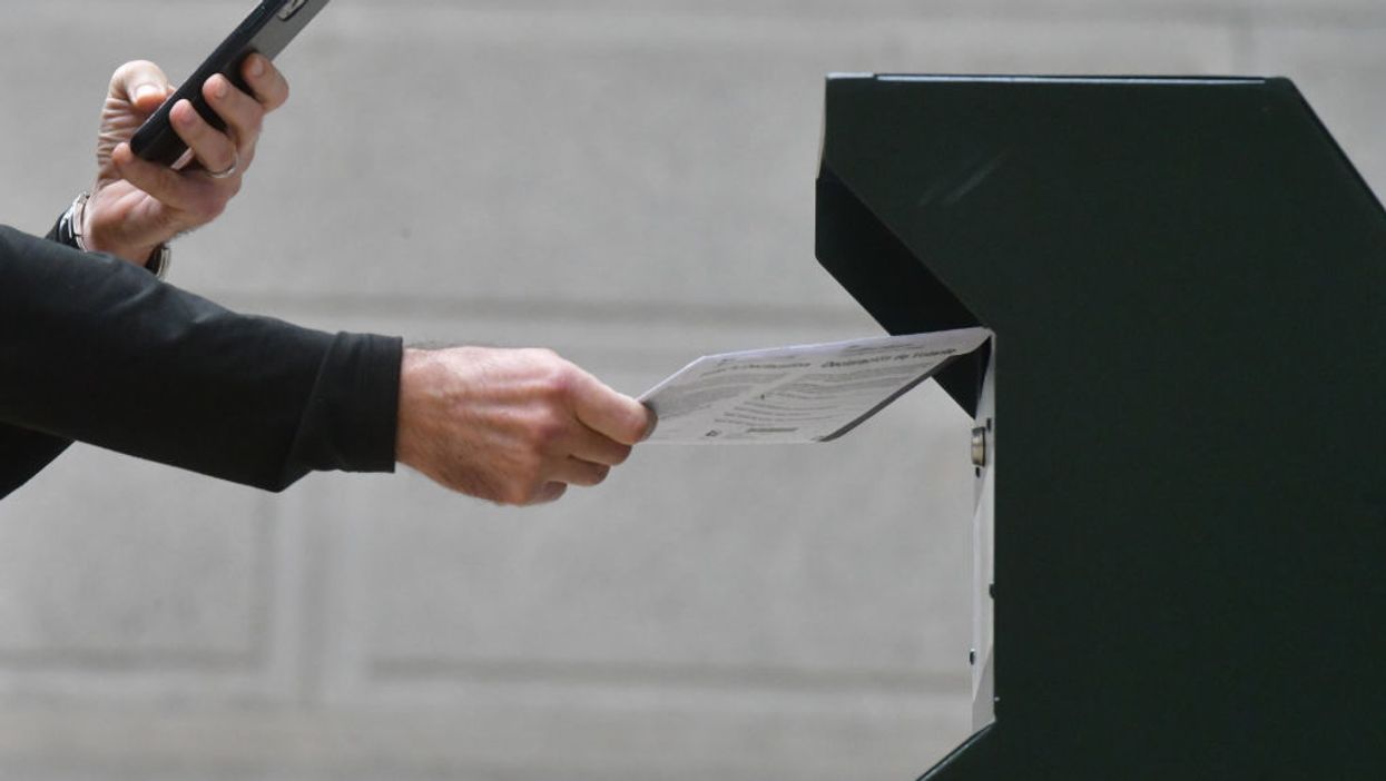 Florida police say 2 men fished mail out of a drop box, stole ballots