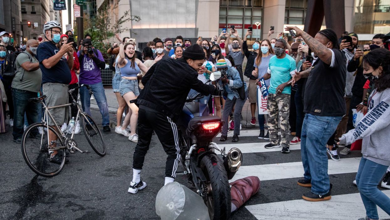 Biden supporters 'murder' effigies of President Trump at packed celebrations across the country